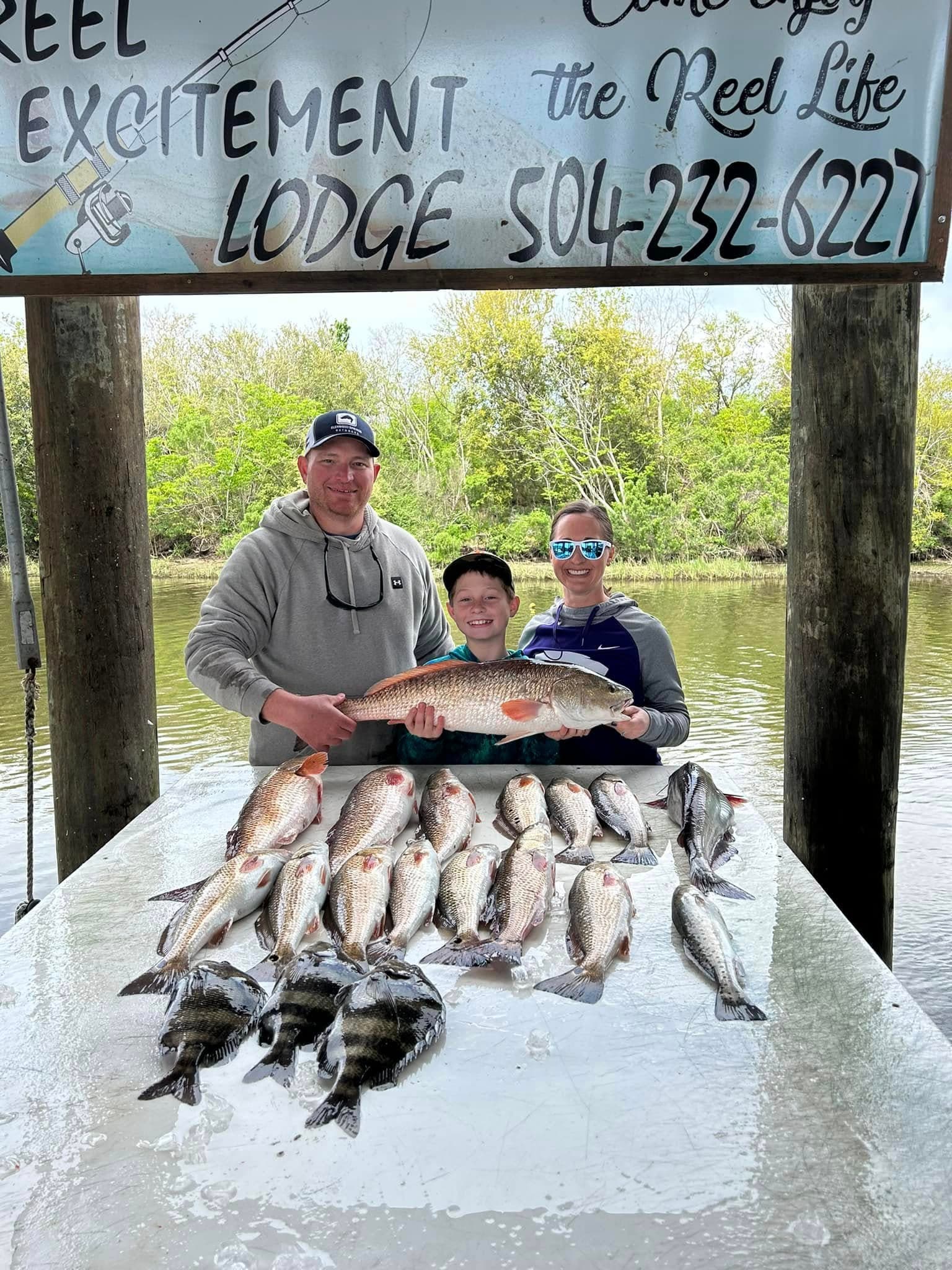 Successful fishing trip at Reel Excitement Charters with family and large catch of redfish and speckled trout